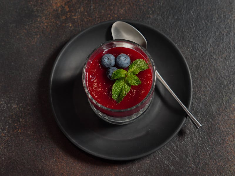 Silky vanilla panna cotta with berry coulis